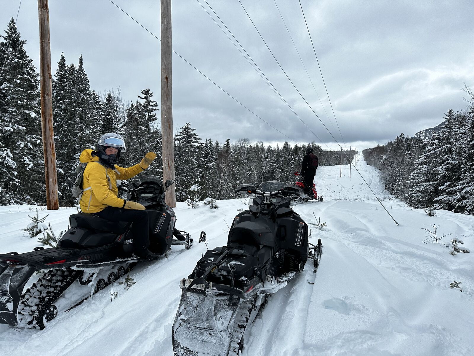 Snowmobiles on a trail near the house