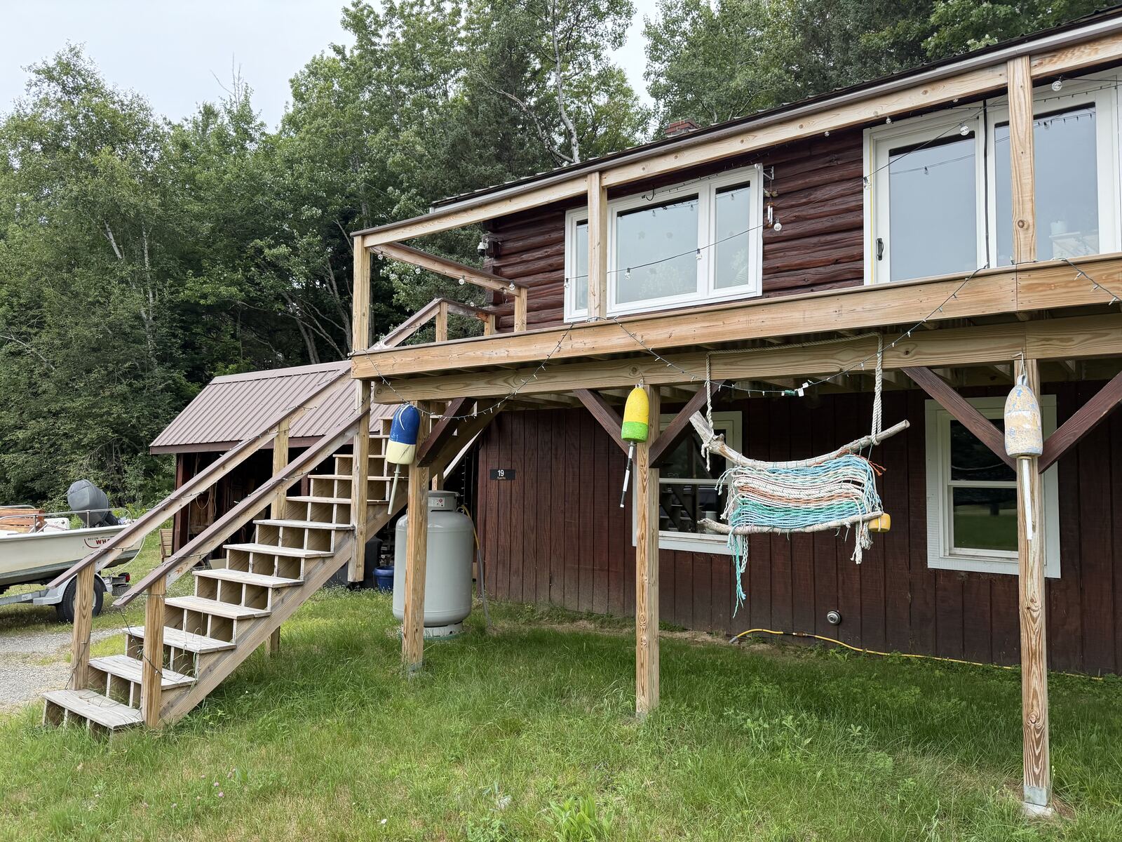 Log home exterior with deck and stairs