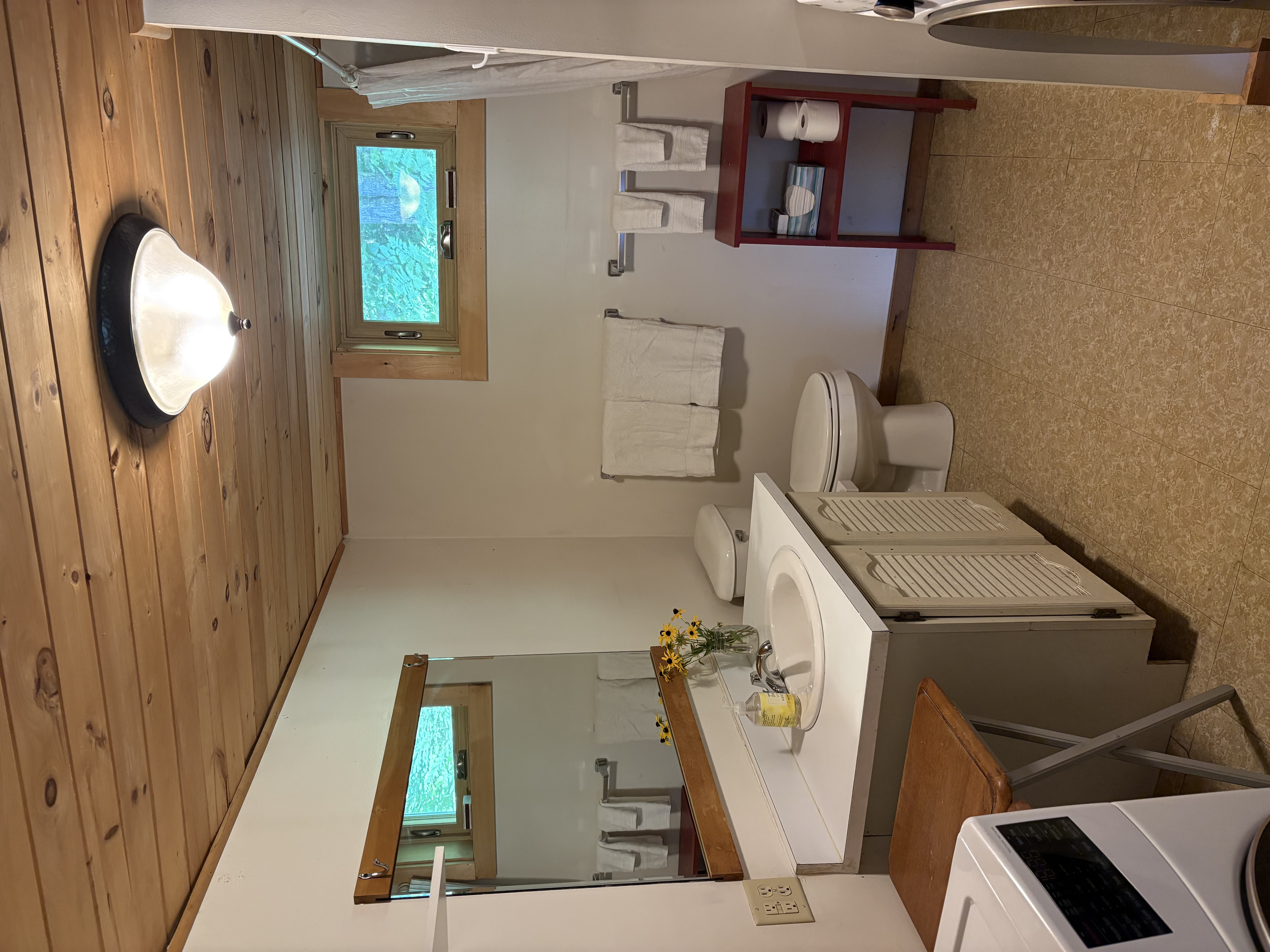 Full bathroom with washer and wood ceiling