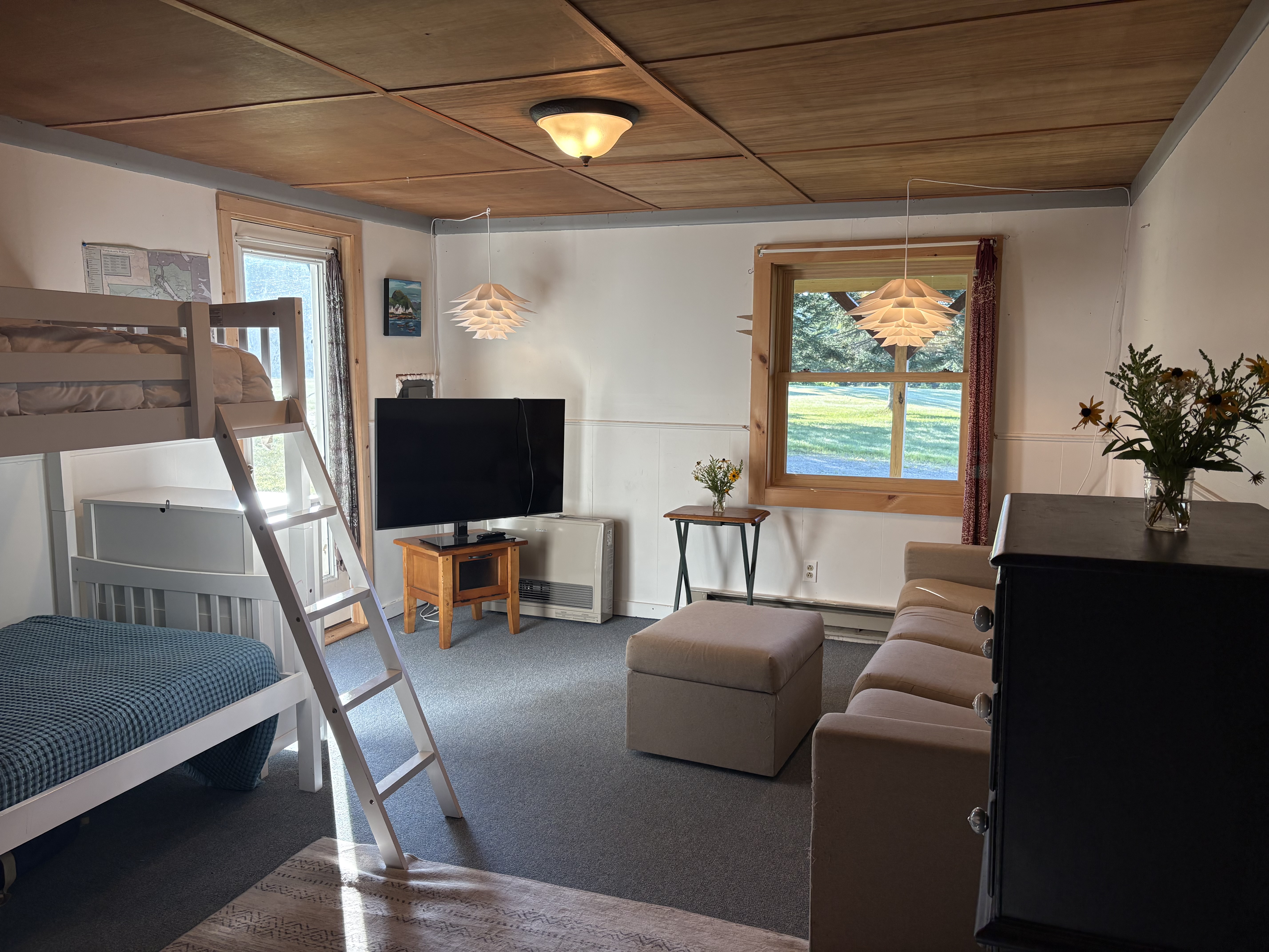 Bunk room with two bunk beds and TV