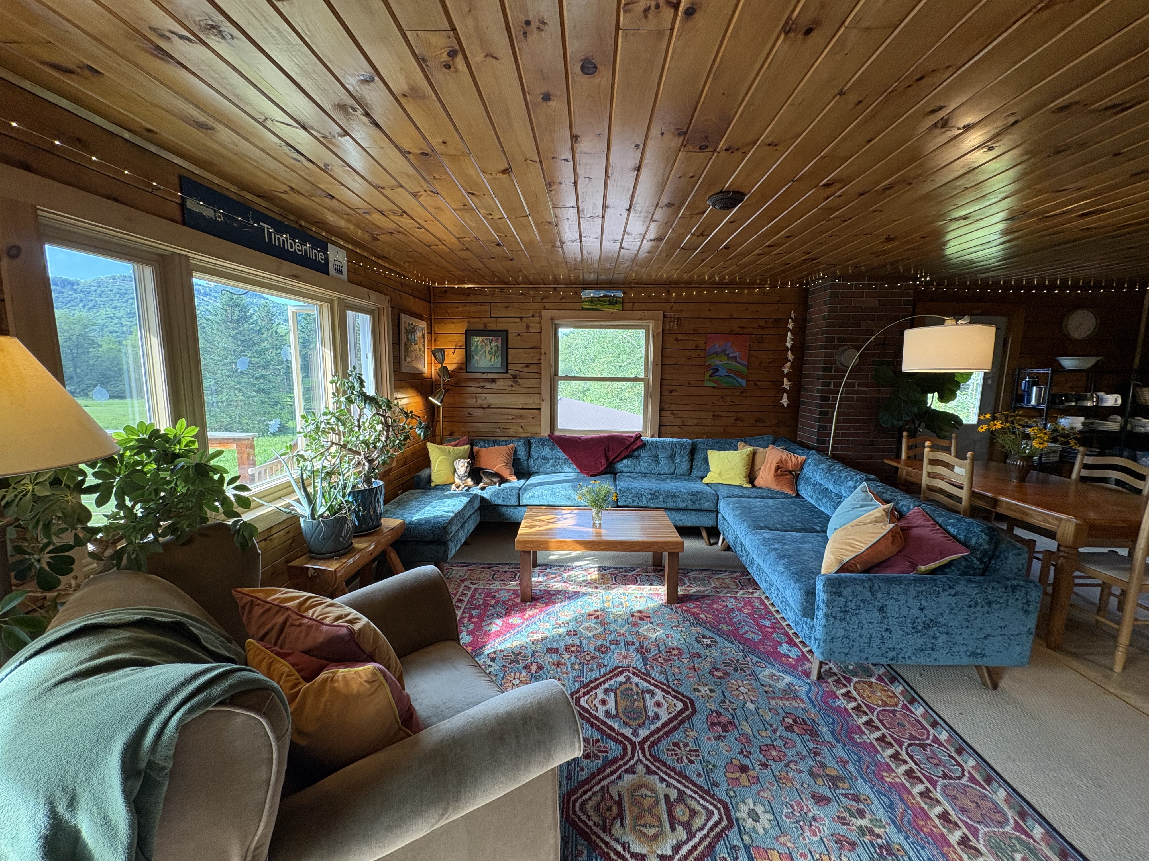 Living room from opposite angle showing mountain views through windows