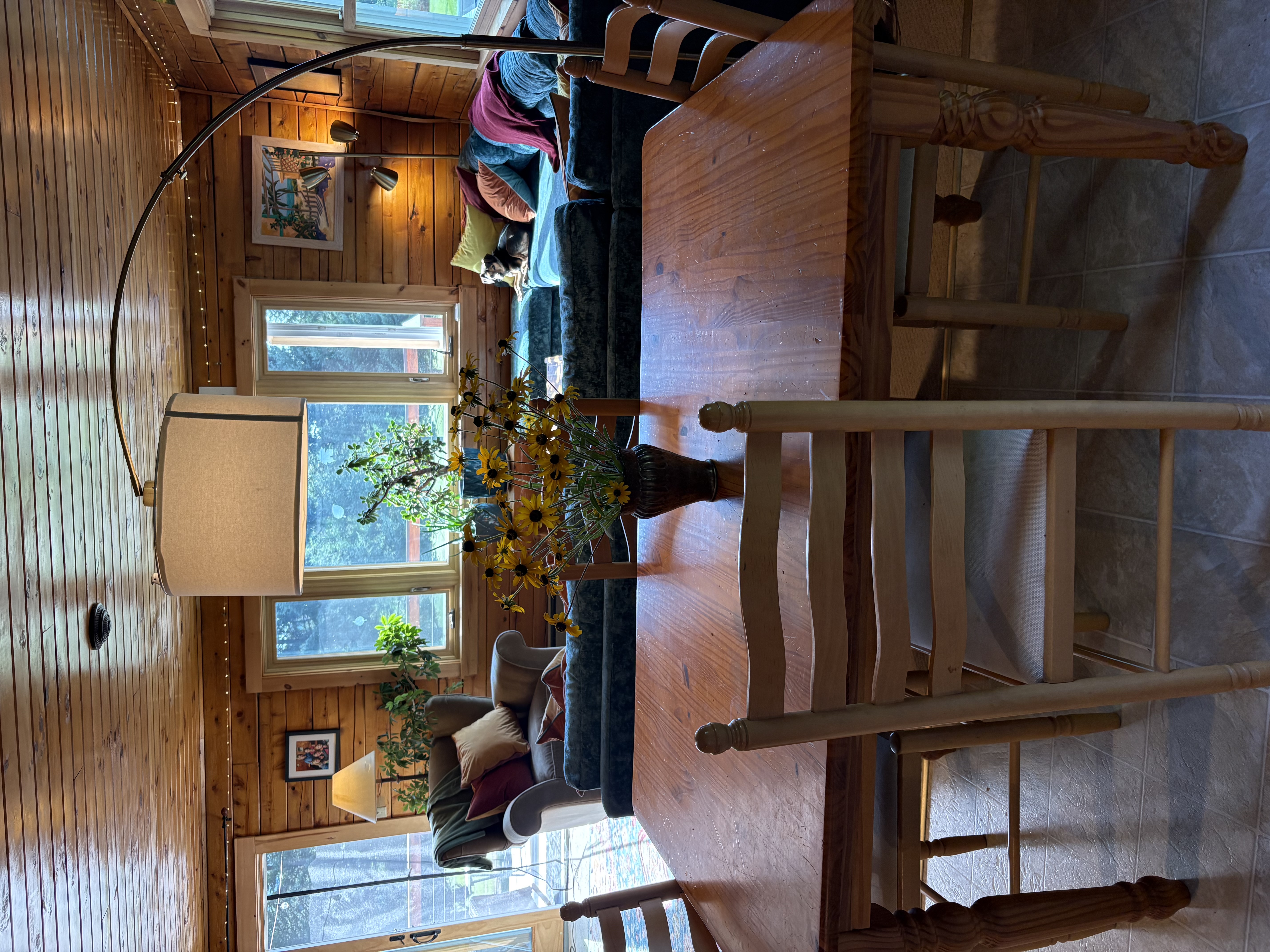 Dining table with living room and sectional sofa beyond