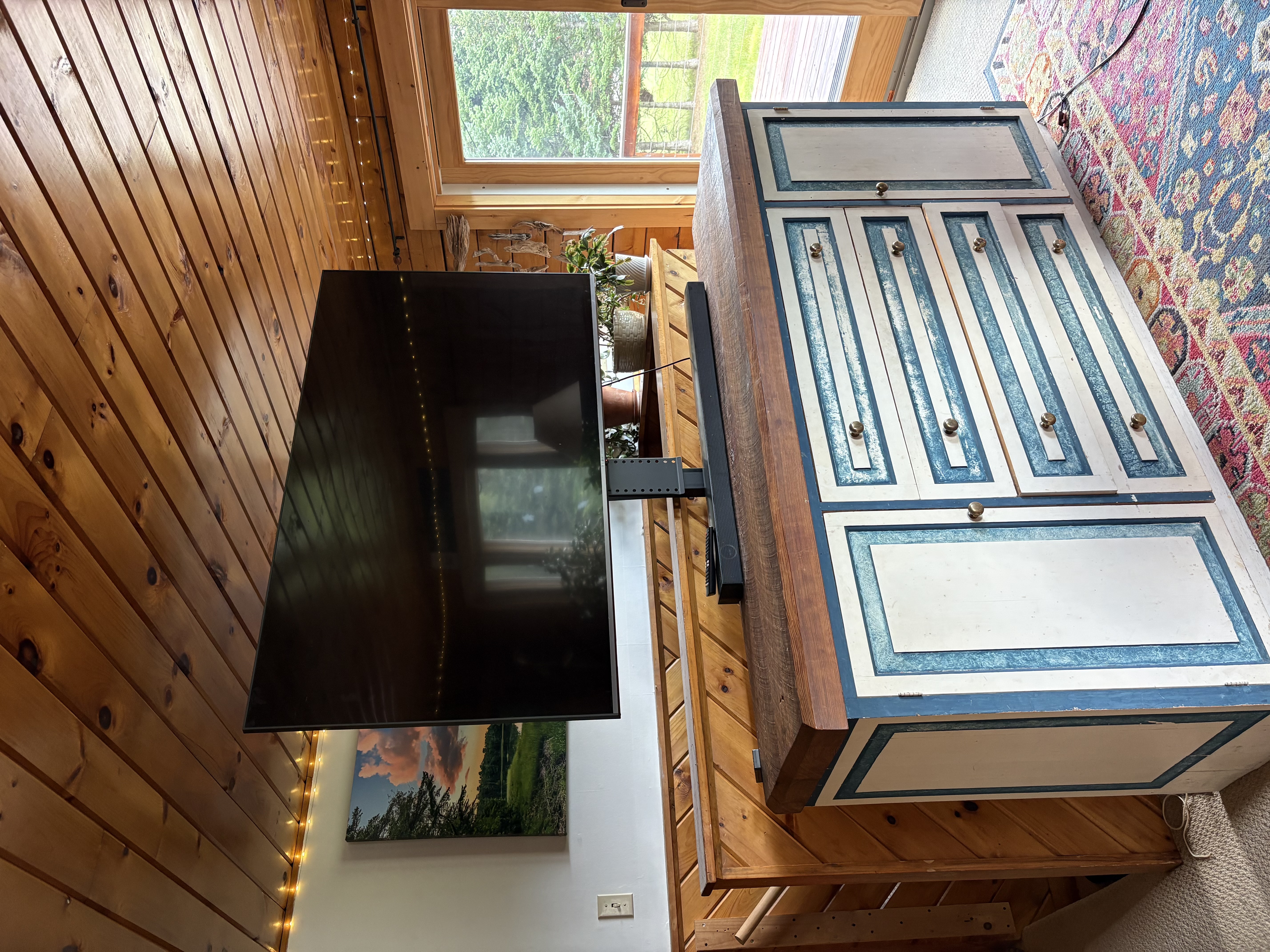 Large flat screen TV on vintage dresser in living room